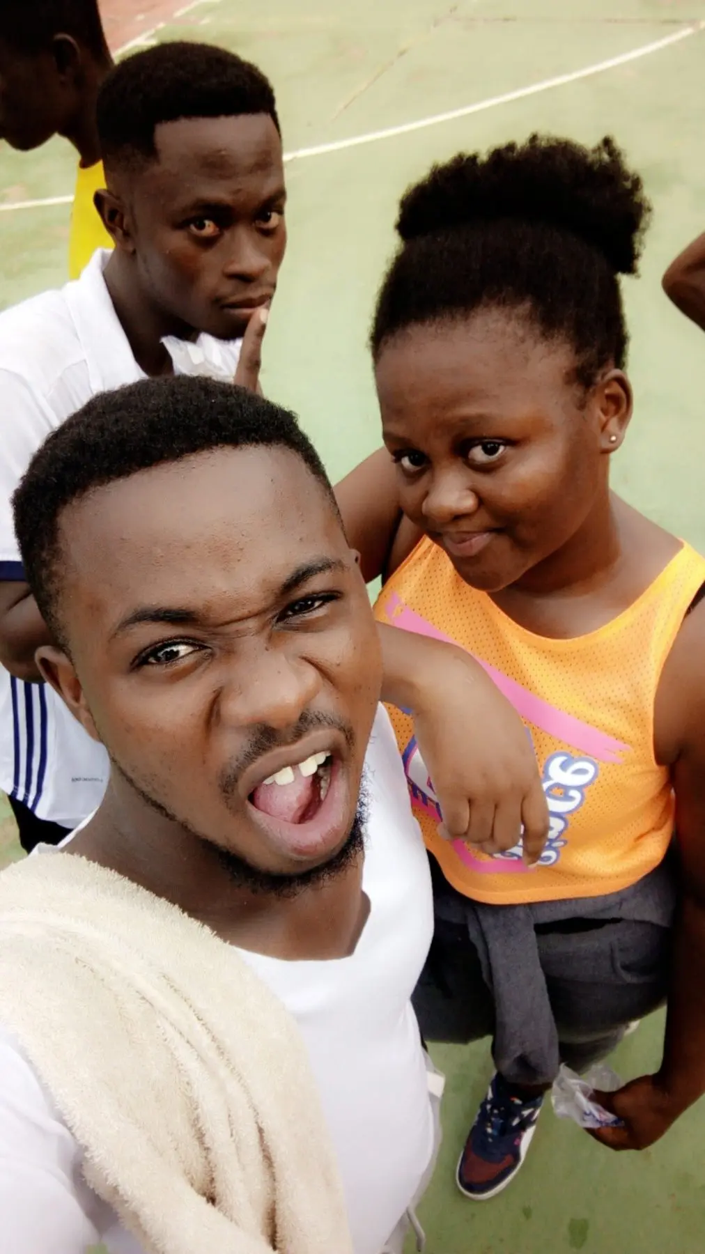 A playful selfie of Noblet and Nancy on a basketball court