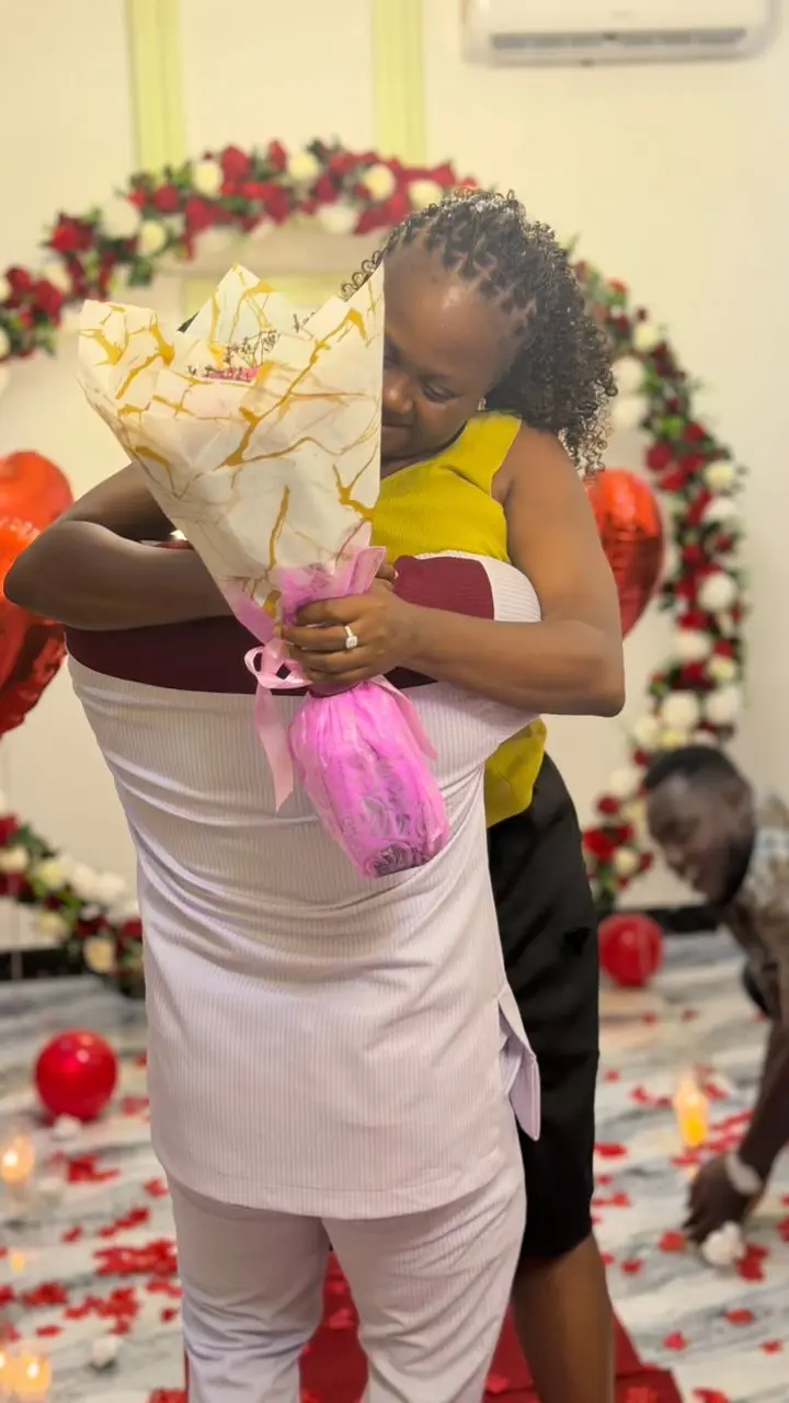 Nancy holds her bouquet and the ring as they hug